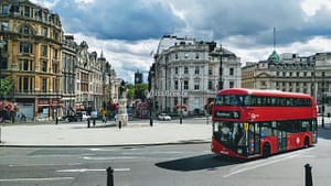 red and black bus on road near building during daytime